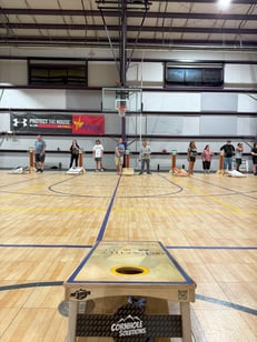 People playing cornhole on The Arena Club Sports Court